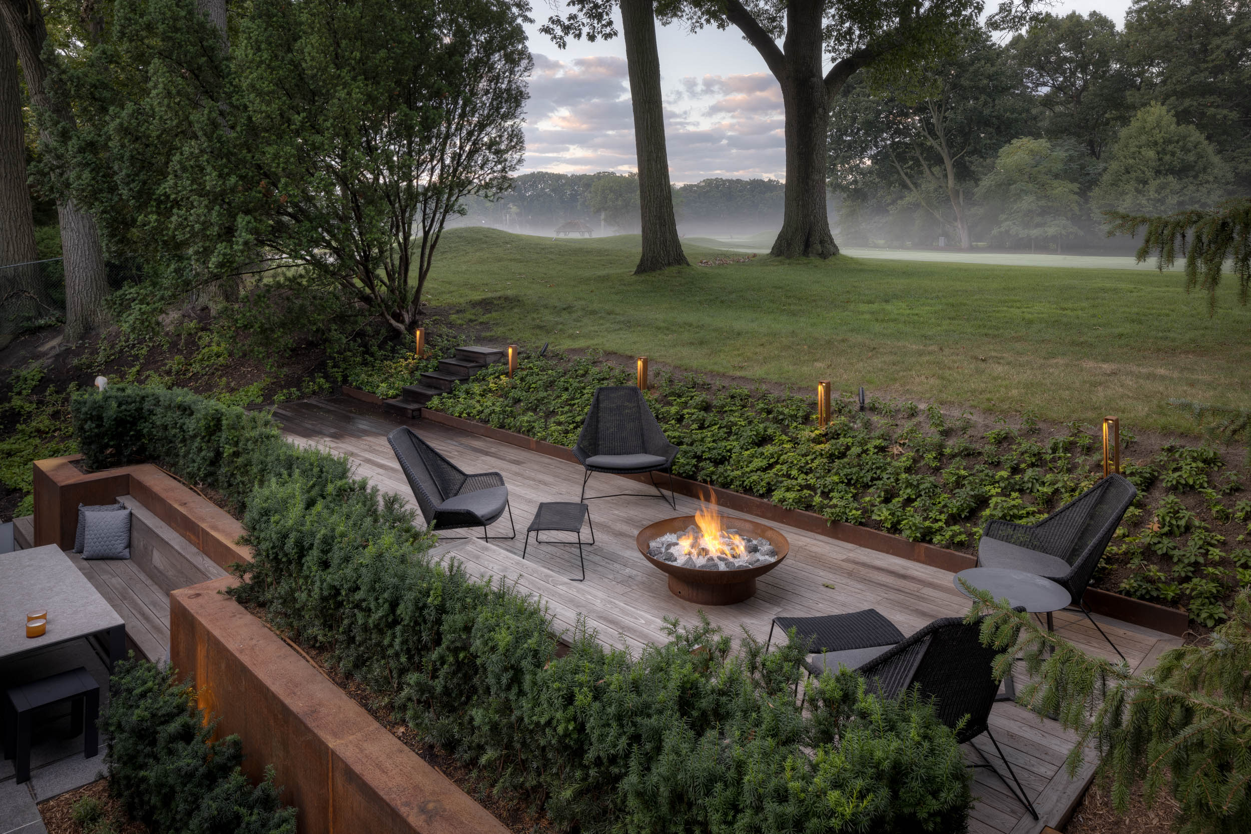 Modern deck with fire table looking out on golf course