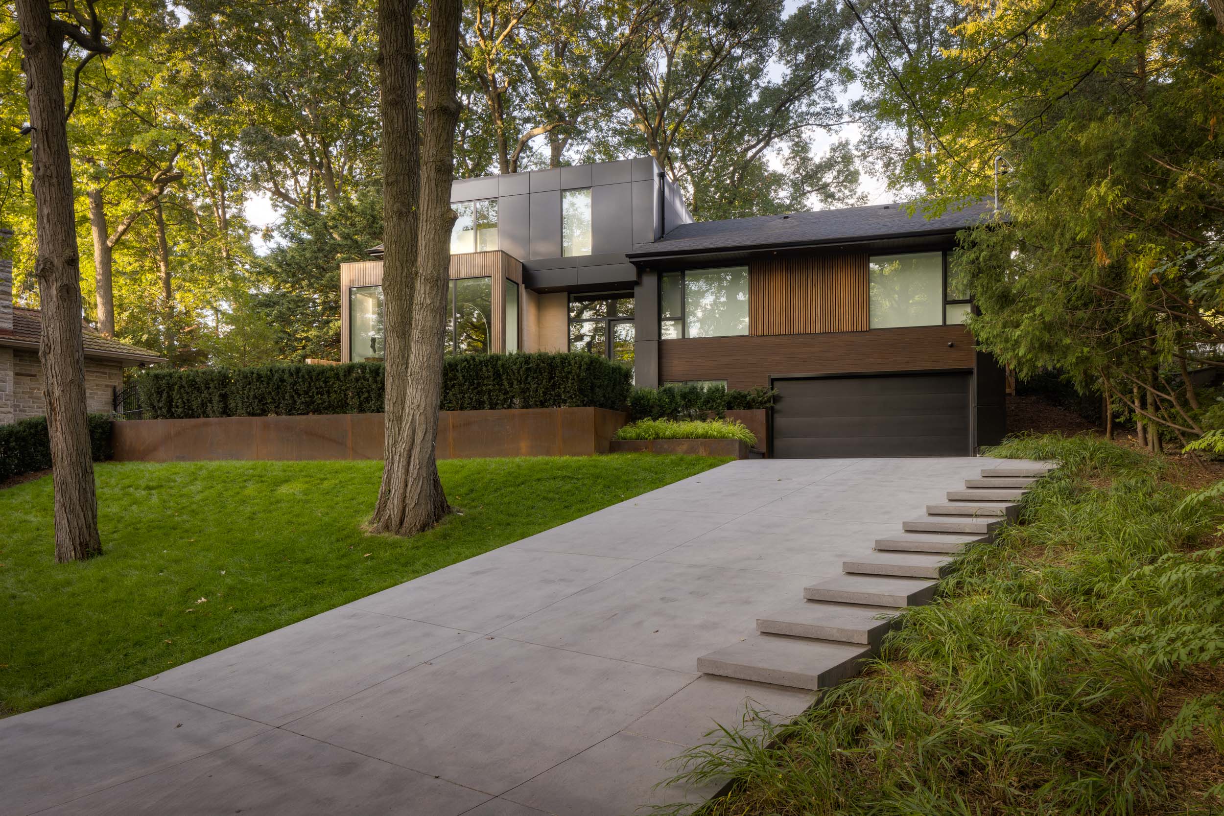 Modern home with sloping driveway integrated steps 