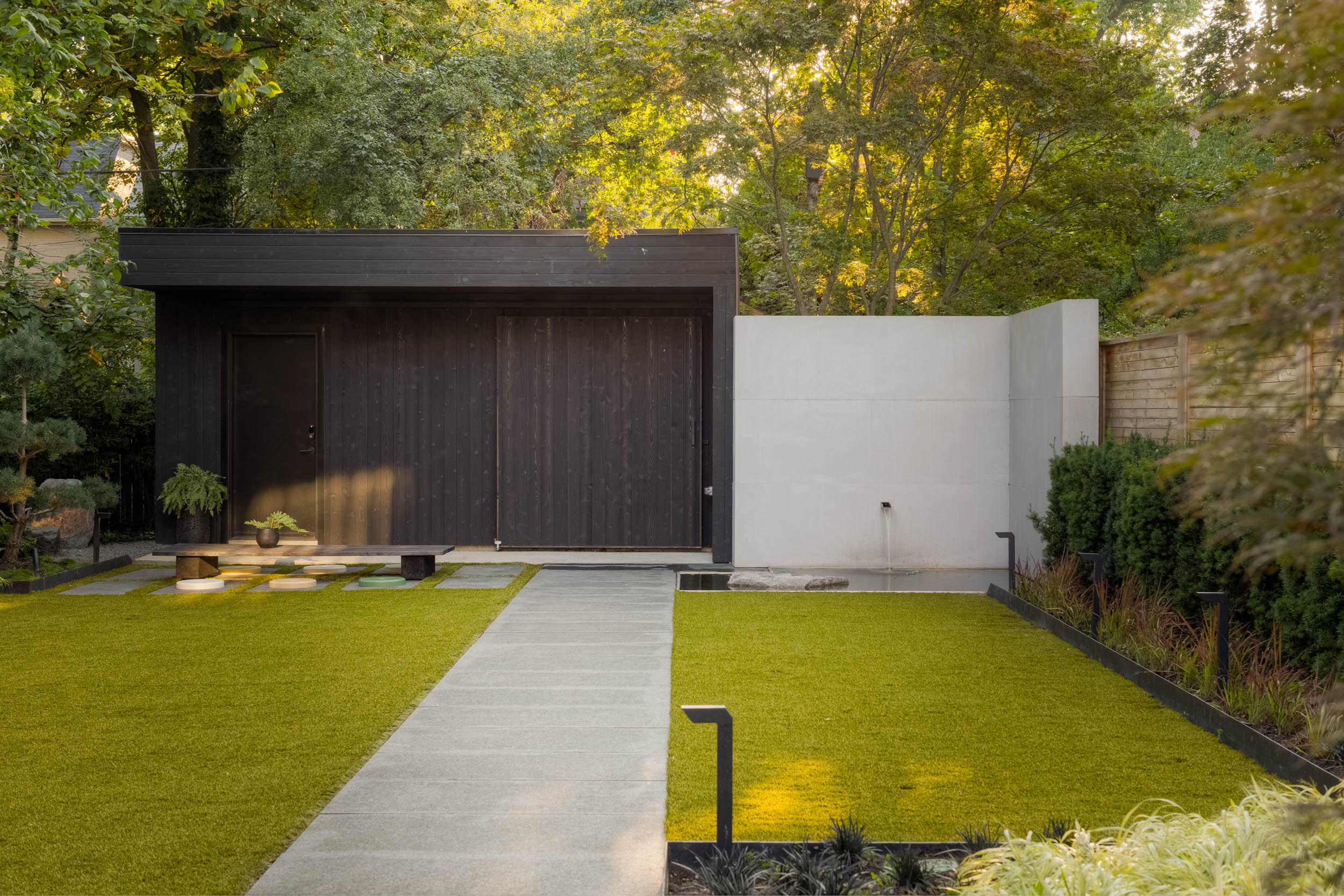 Zen garden with center path leading to garage